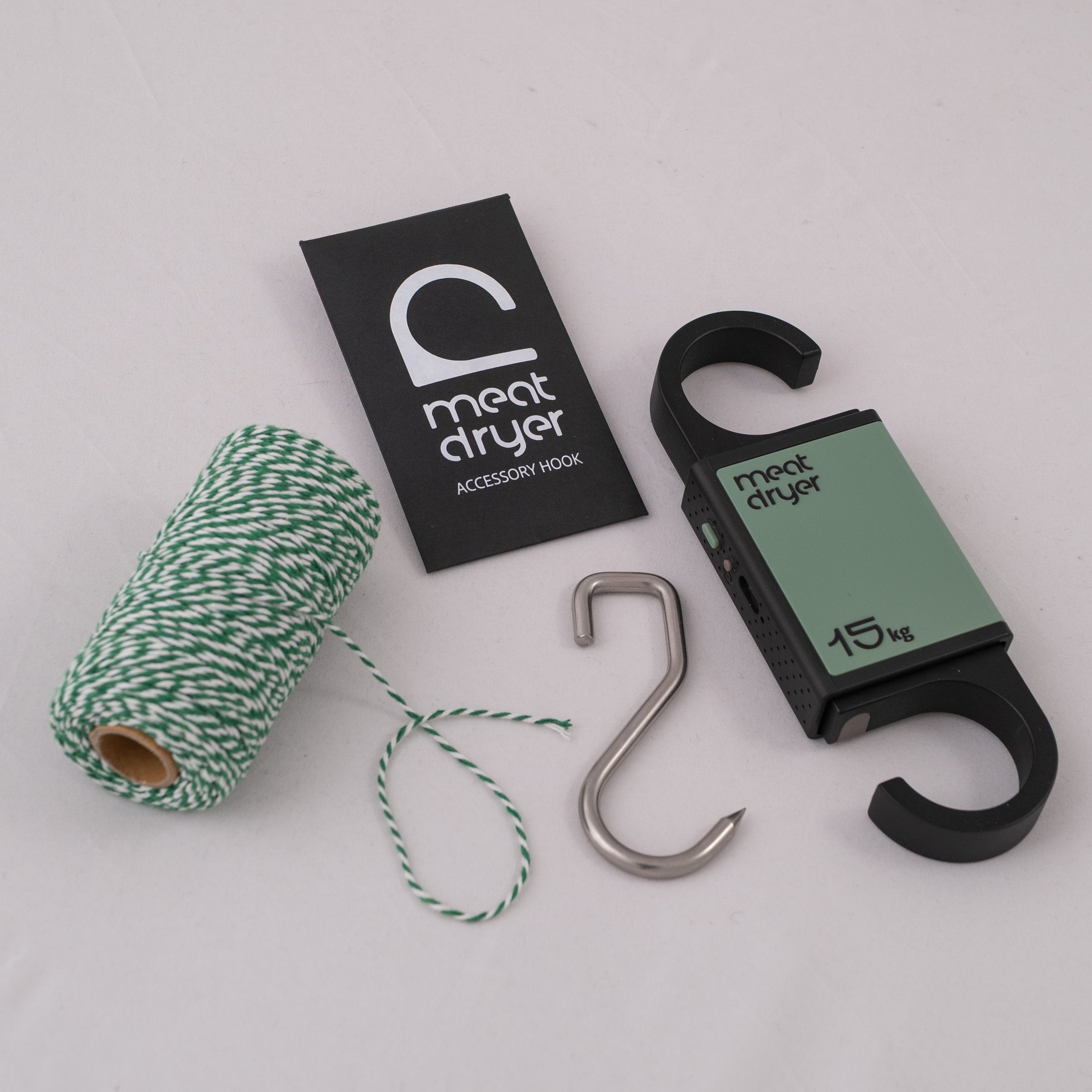 Meatdryer accessory hook with a roll of twine and a steel meat metal hook on a white background