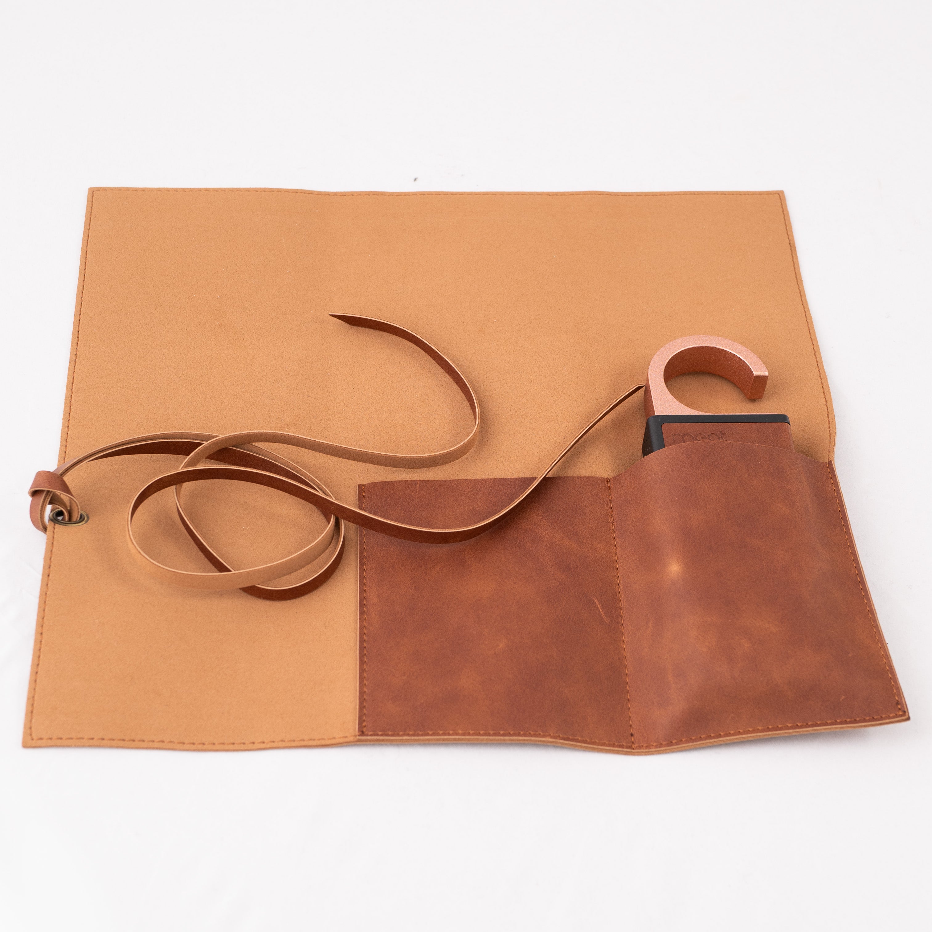 Brown tool roll with strap on a white background