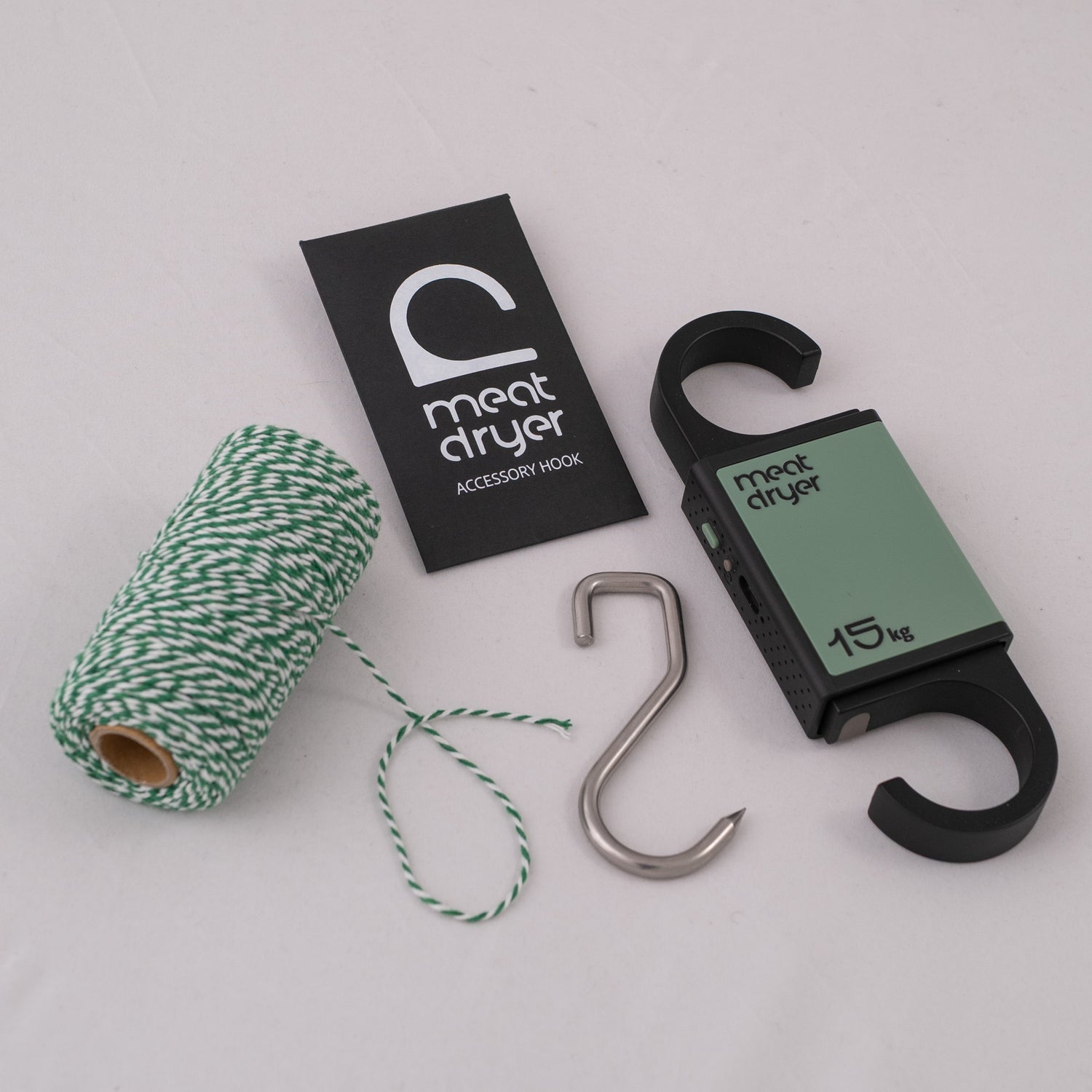 Meatdryer accessory hook with a roll of twine and a steel meat metal hook on a white background